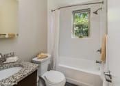 Thumbnail 23 of 27 - a bathroom with a bathtub and toilet in a 555 waverly unit